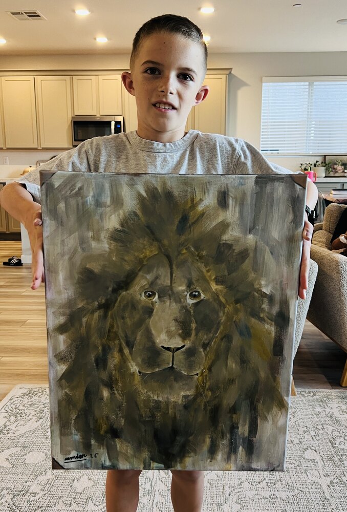 Camden holding up his painting Old Lion